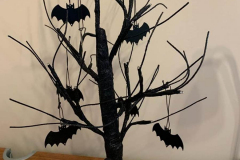 The tree with the branches spread and the bats on the branches