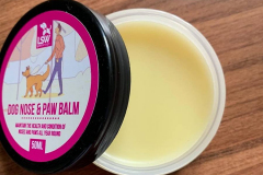 The pot of balm with the lid off