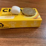 Side on size comparison of the gum and a one pound coin