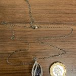 Necklace compared to a one pound coin