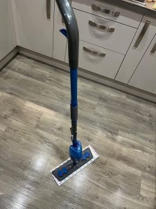 Spray mop on a shining floor that has just been cleaned by it